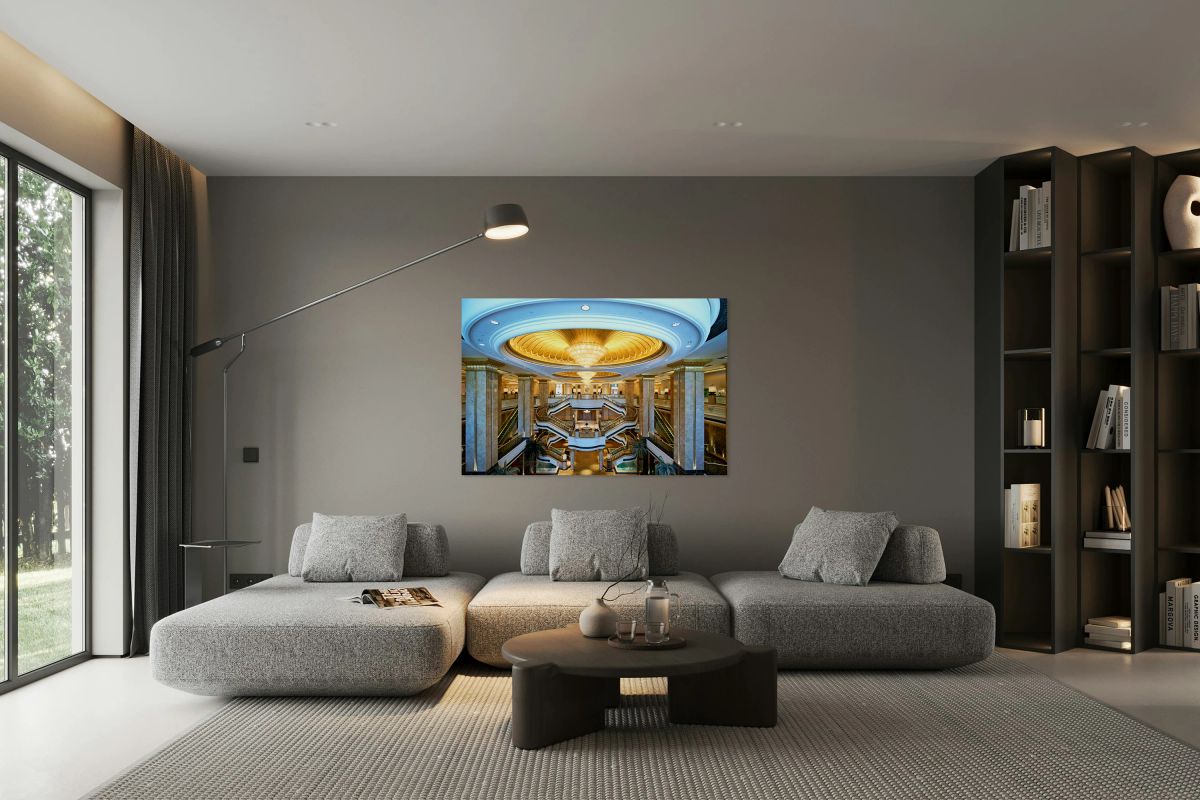 Opulent hotel lobby with grand staircases and golden dome.