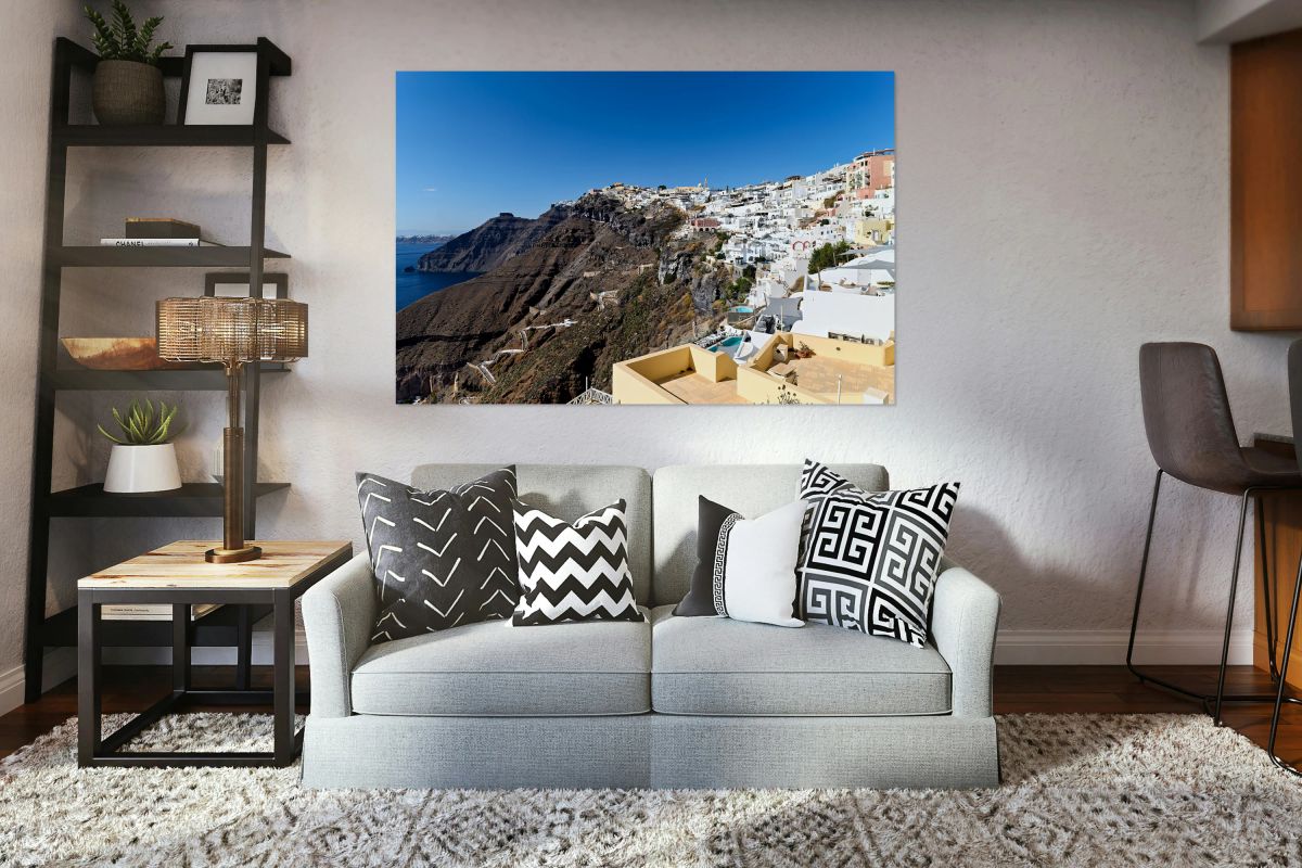 Picturesque Santorini village on cliff overlooking the sea.