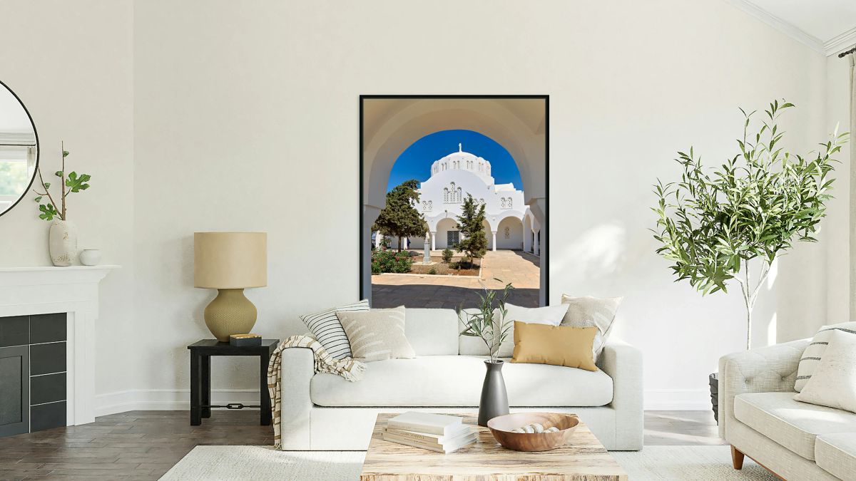 White domed church through an archway in Greece.