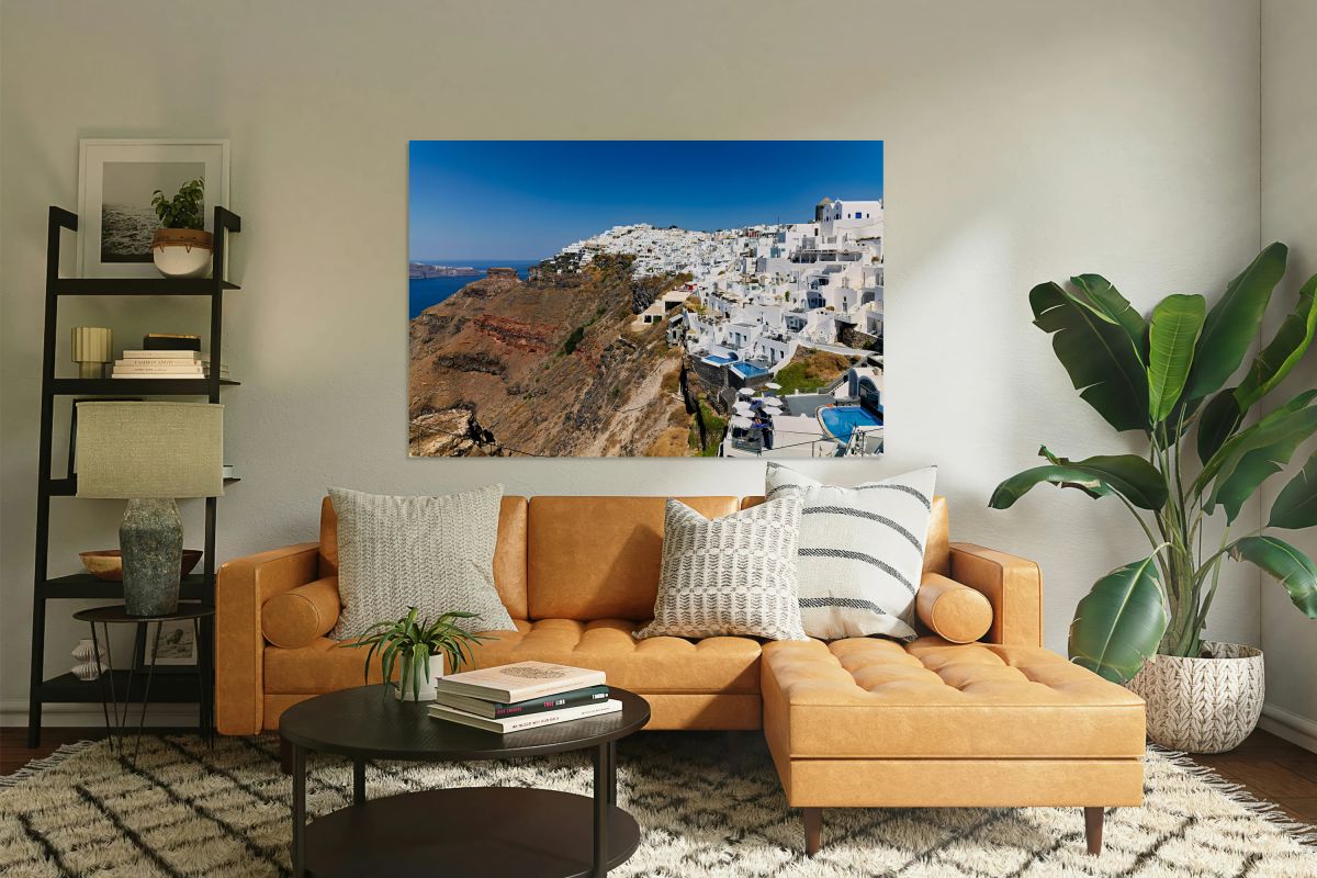 Santorini: White cliffside village blue sea clear sky.