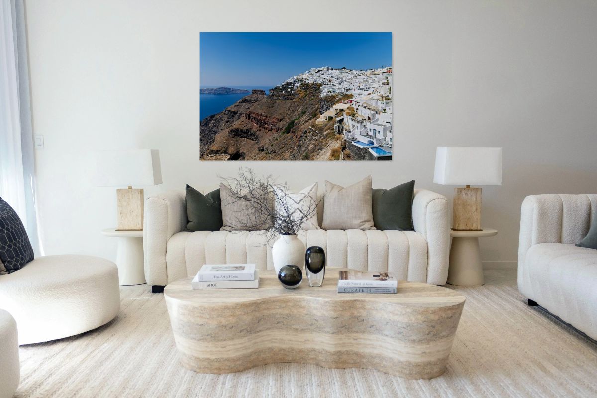 Santorini village on cliff overlooking caldera and sea.