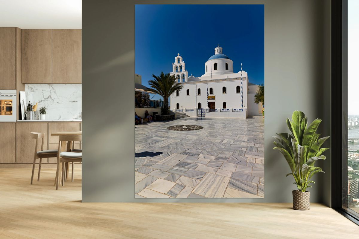 White Greek church with blue dome bell tower and marble courty