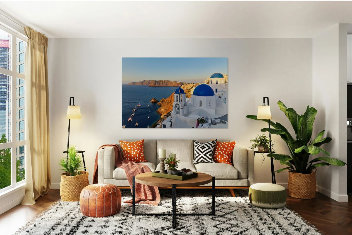 Santorinis beautiful blue domed churches caldera and sea.