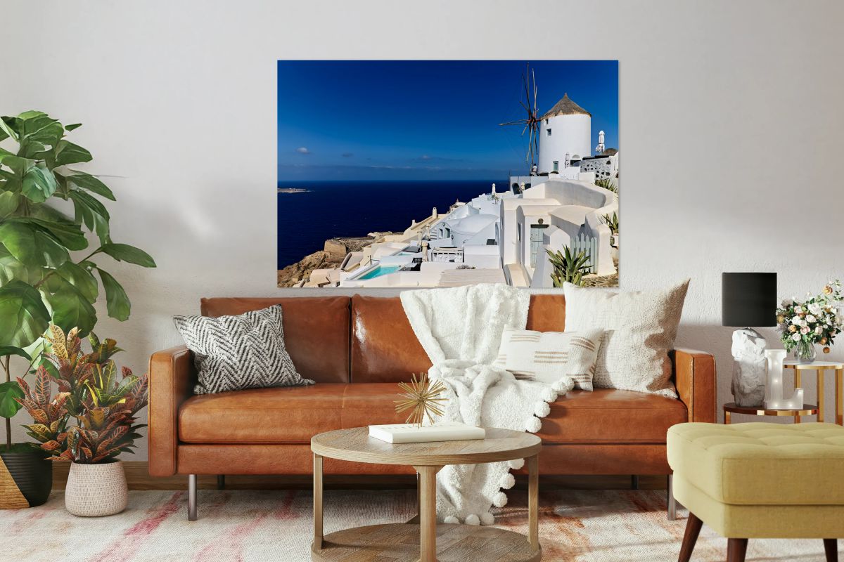 Santorinis iconic white architecture and windmill against the d