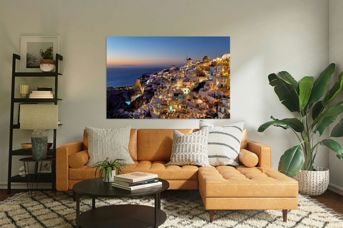 Santorinis Oia village illuminated at dusk overlooking the se