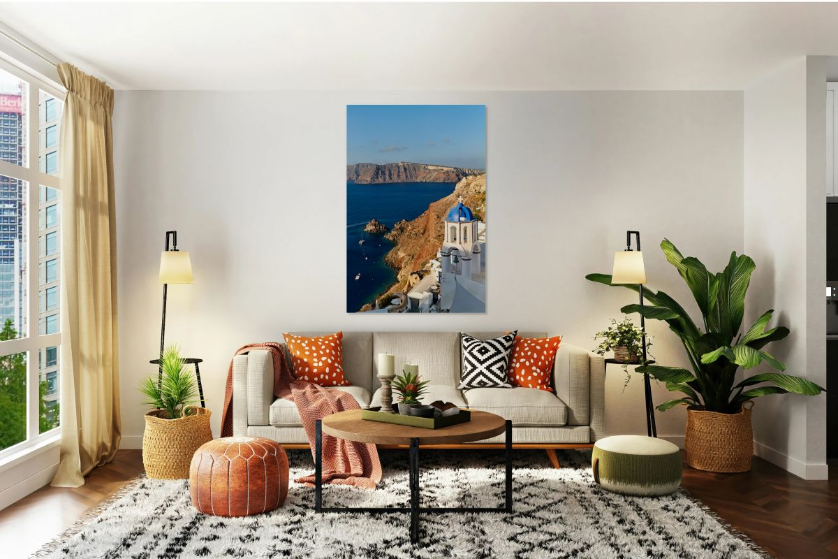 Santorinis iconic blue domed church overlooks the caldera and v