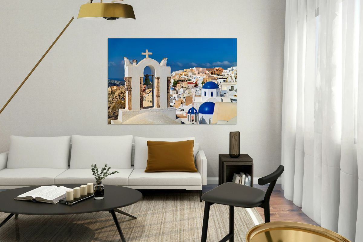 Santorinis iconic bell tower white houses blue domes caldera