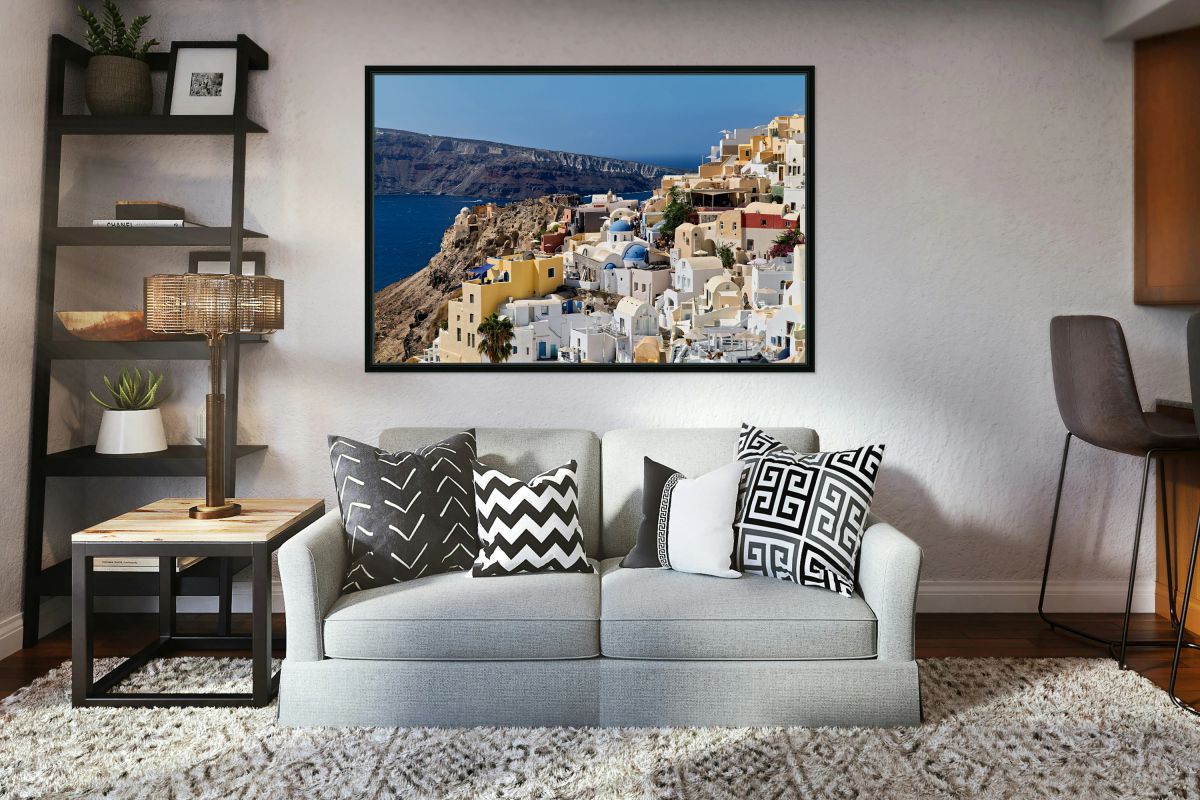 Picturesque Santorini village on cliff overlooking Aegean Sea.