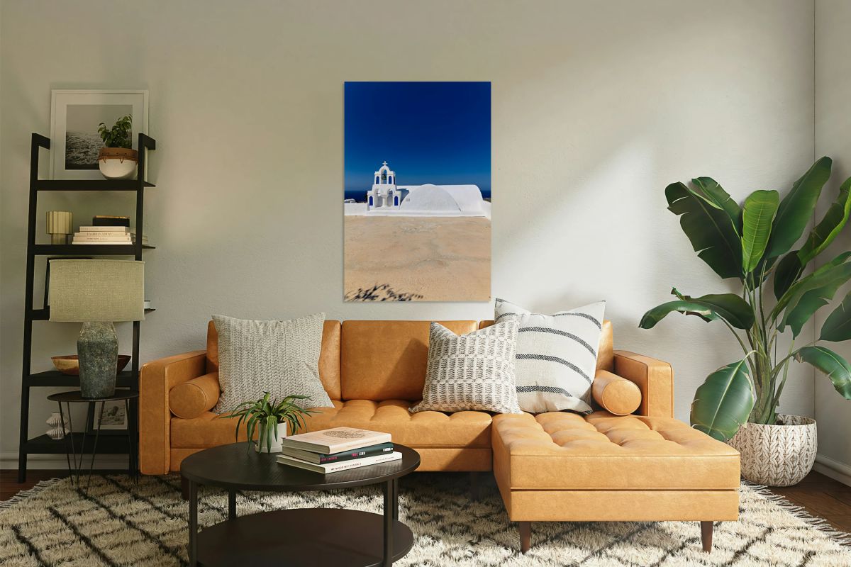 Traditional white and blue Greek church against a clear sky.