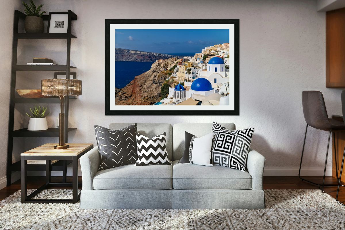 Santorinis iconic white buildings and blue domes overlooking th
