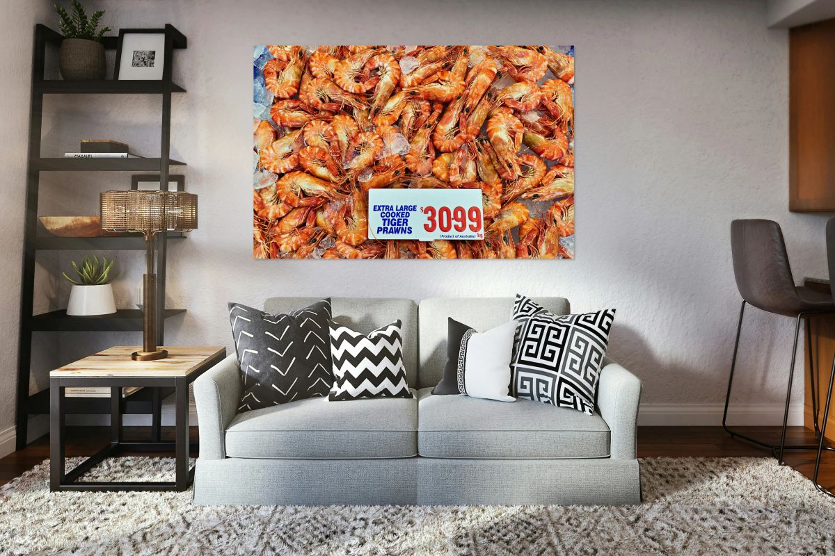 Extra large cooked tiger prawns on ice for sale.