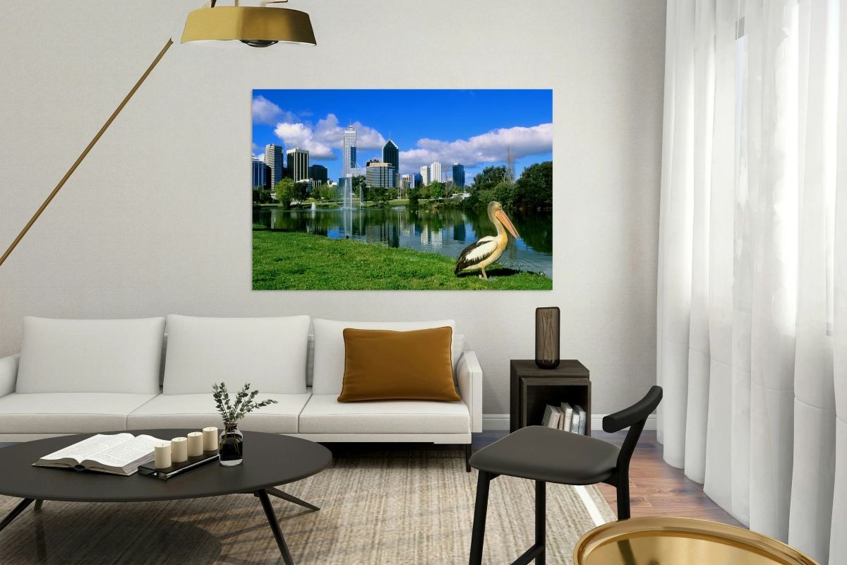 A pelican poses before the Perth Australia city skyline.