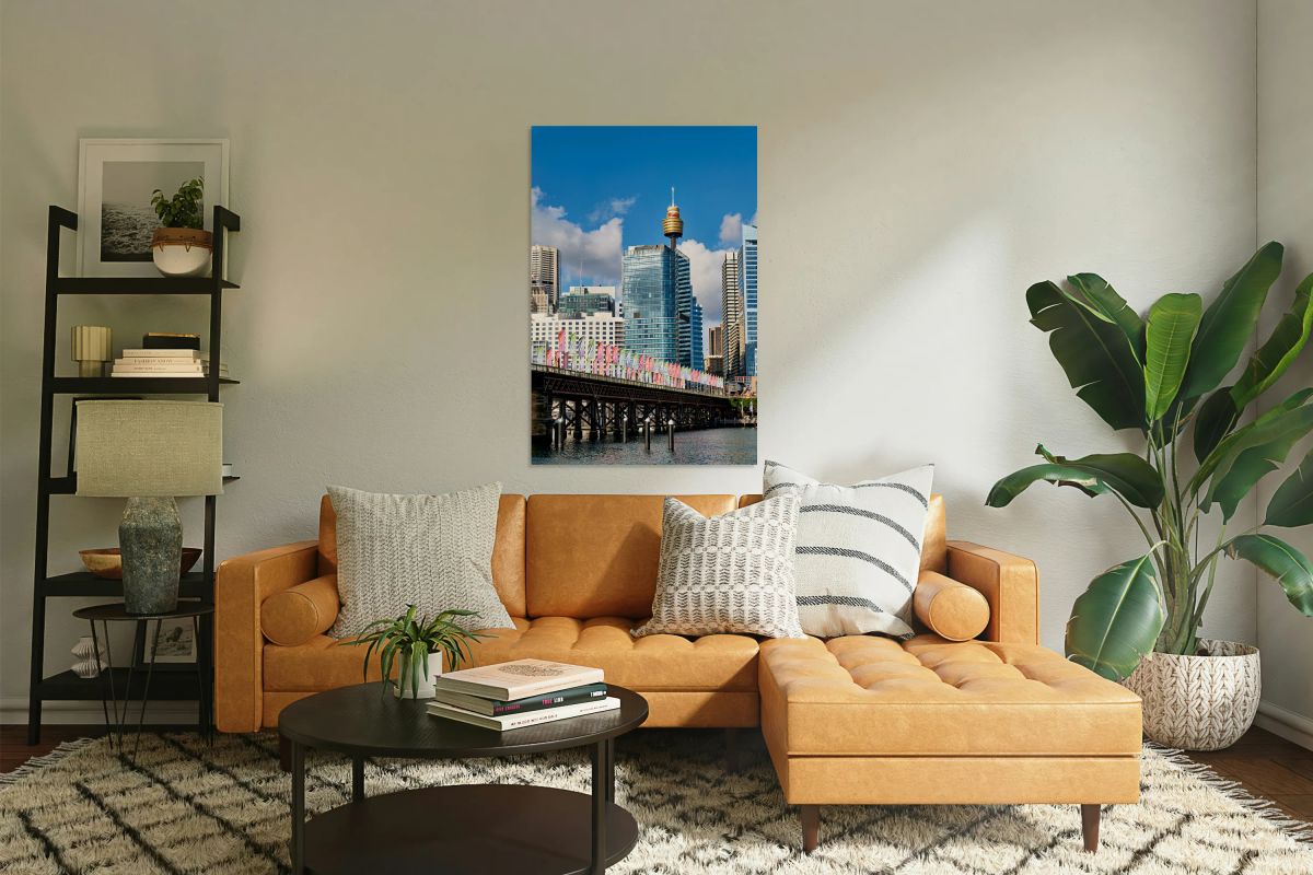 Sydney Harbour Bridge with colorful flags and city skyline.