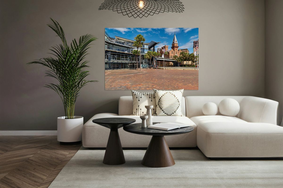 Modern building and historic tower by the water.