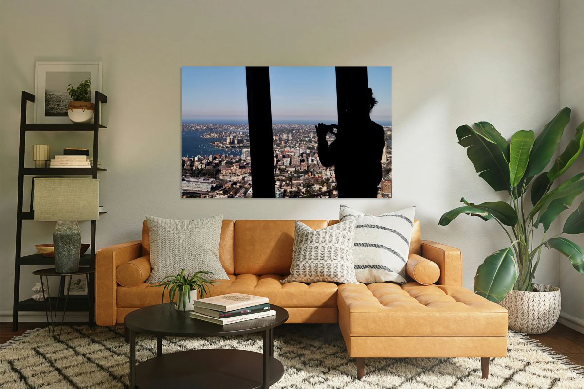 Silhouette of person taking photo of Sydney cityscape.