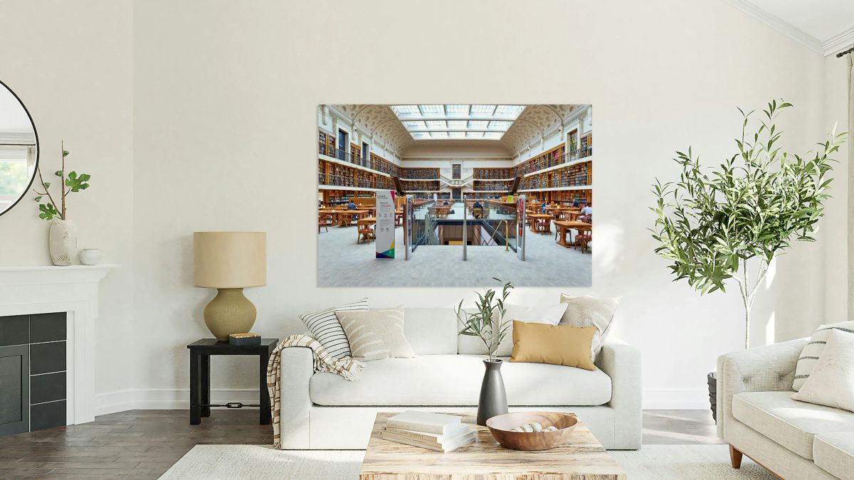 Spacious library with ornate ceiling books and people studying