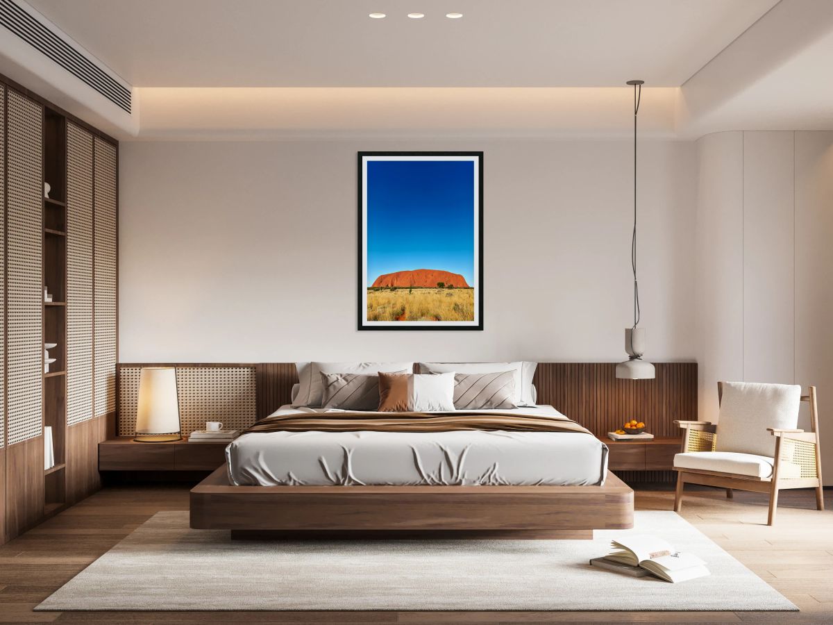 Uluru monolith under a clear blue sky.