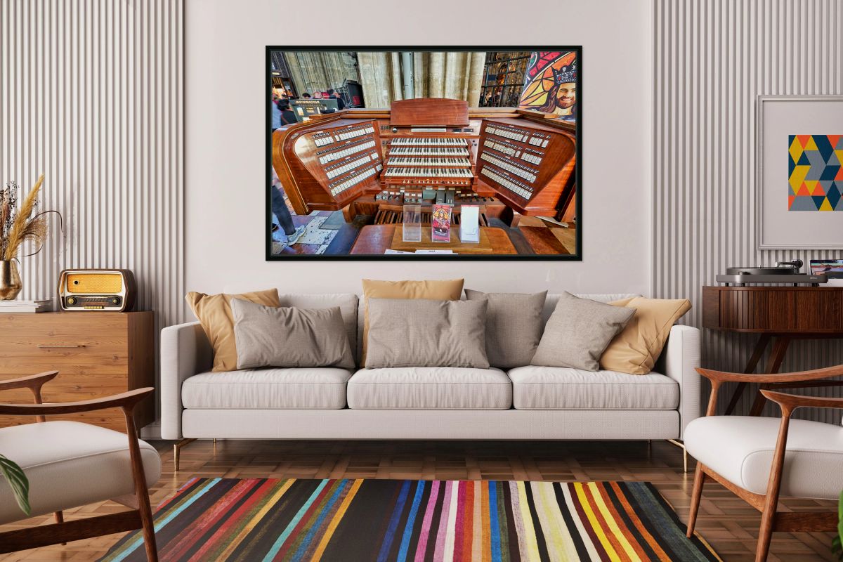 Intricate wooden pipe organ console with multiple keyboards and 