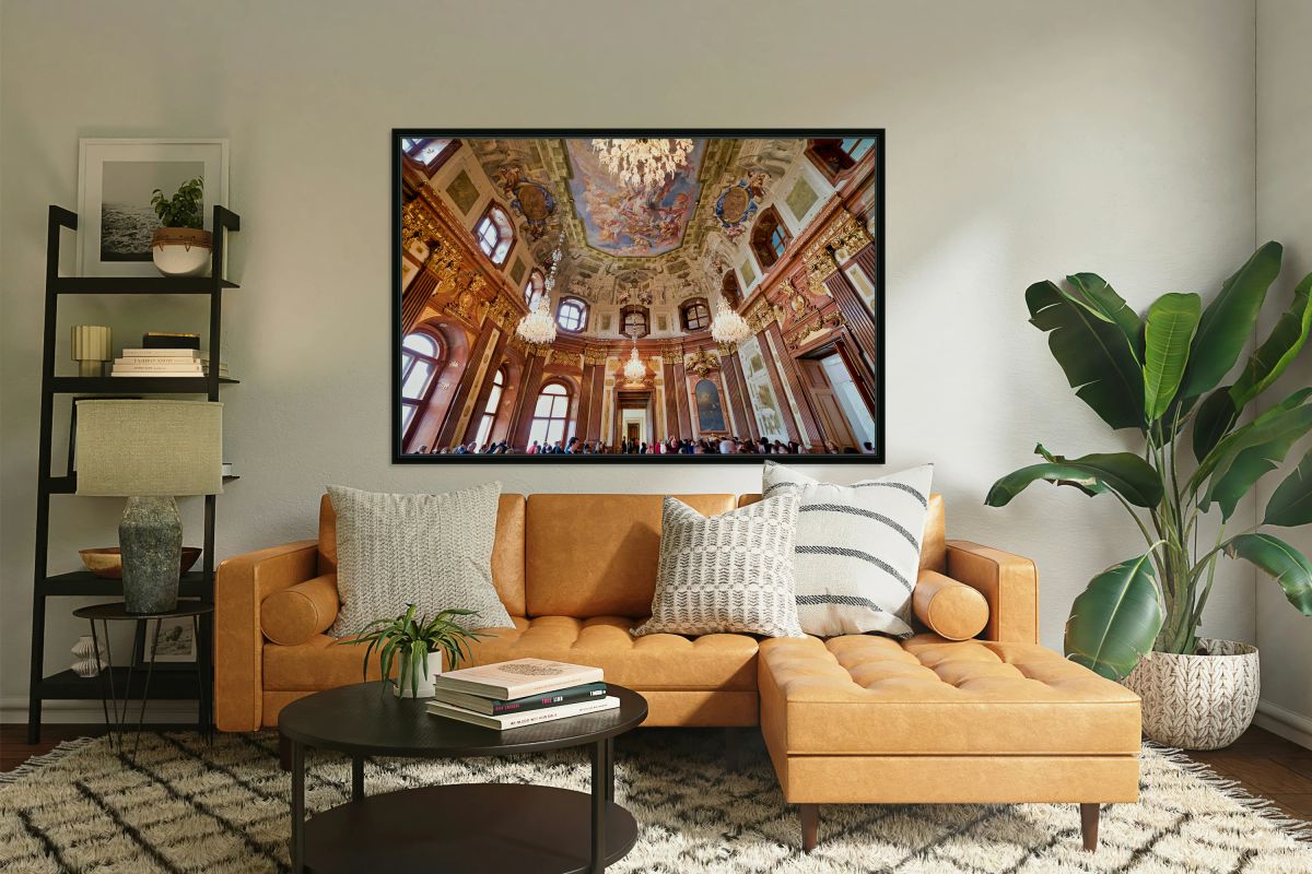 Ornate baroque hall with painted ceiling and chandeliers.