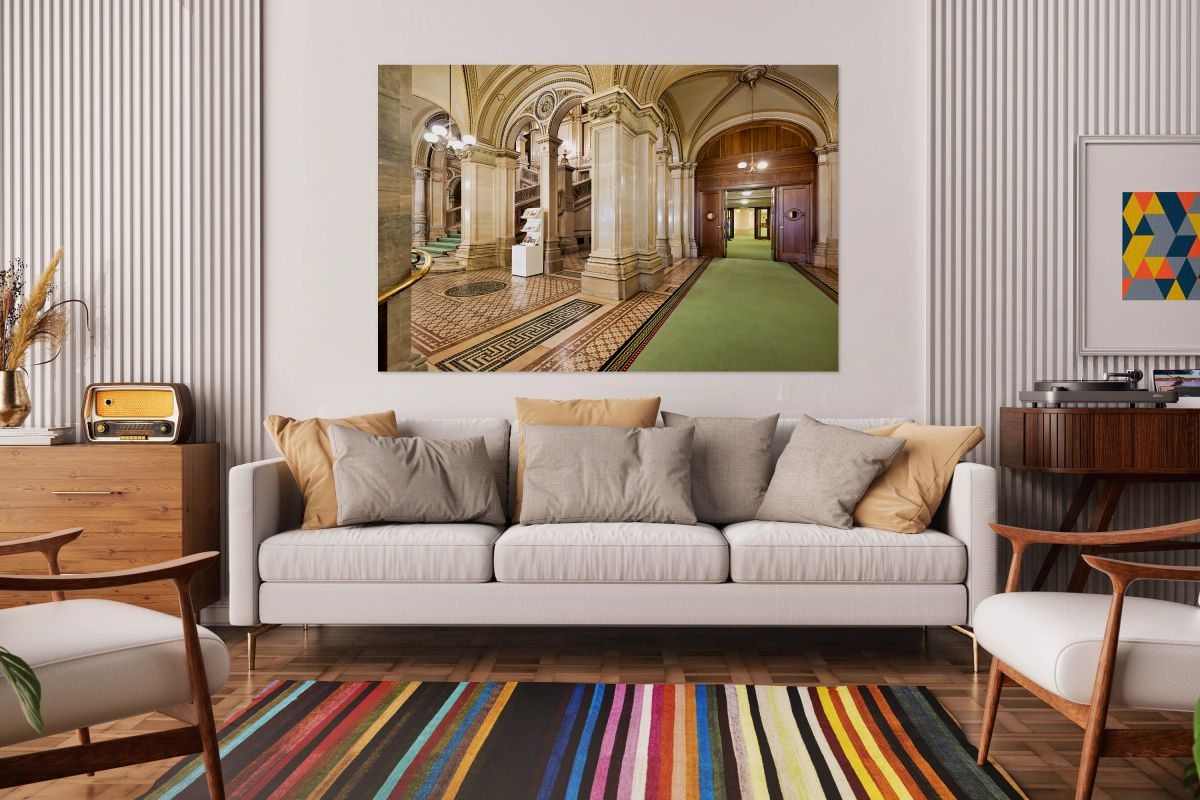 Ornate interior with grand staircase arches and patterned floo