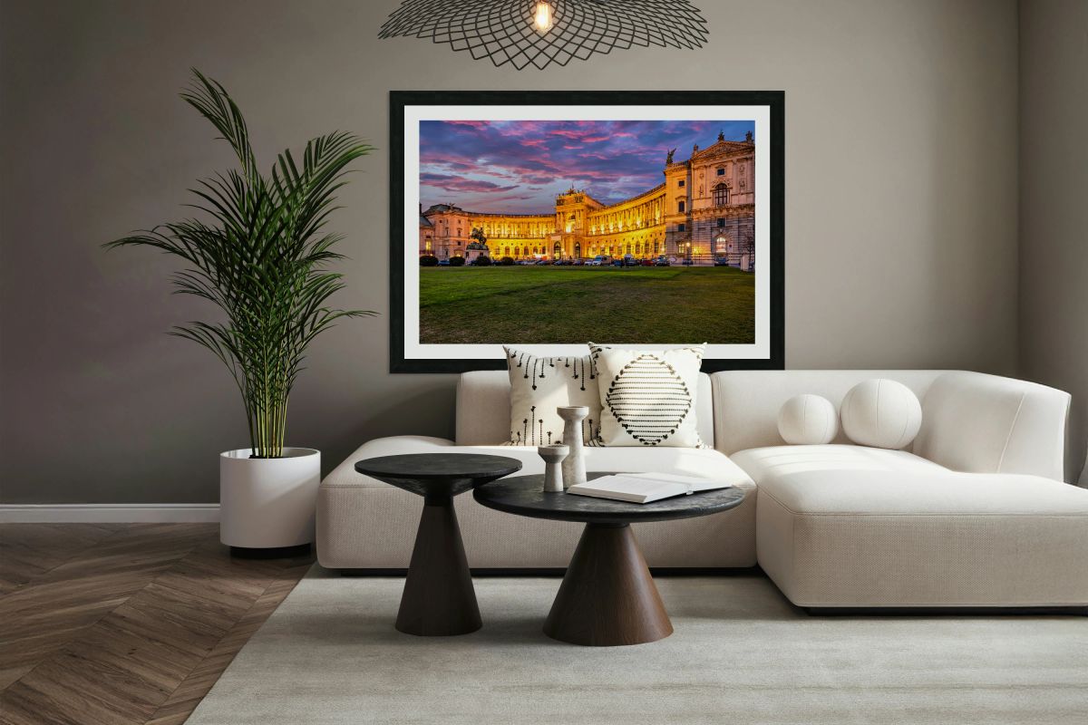 Illuminated Hofburg Palace in Vienna at sunset with vibrant sky.
