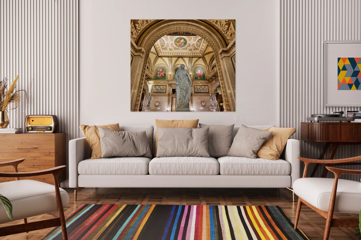 Ornate hall with classical statue and elaborate ceiling art.