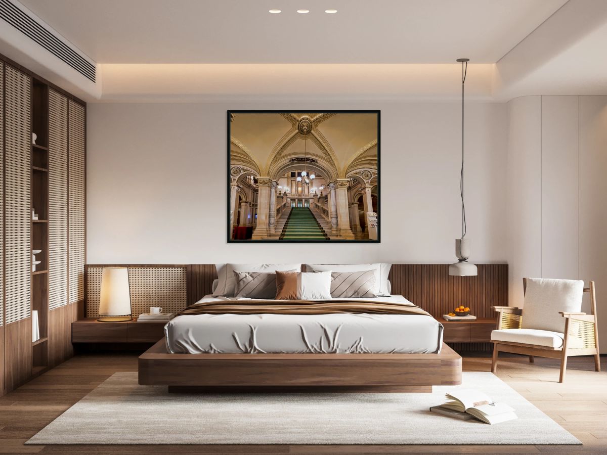 Majestic staircase with green carpet in an ornate hall.