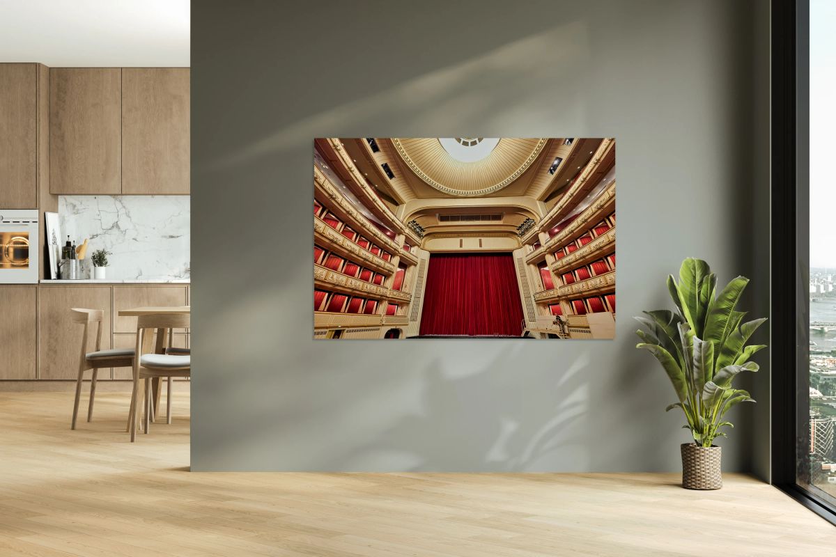 Grand opera house interior with red stage curtain and balconies.