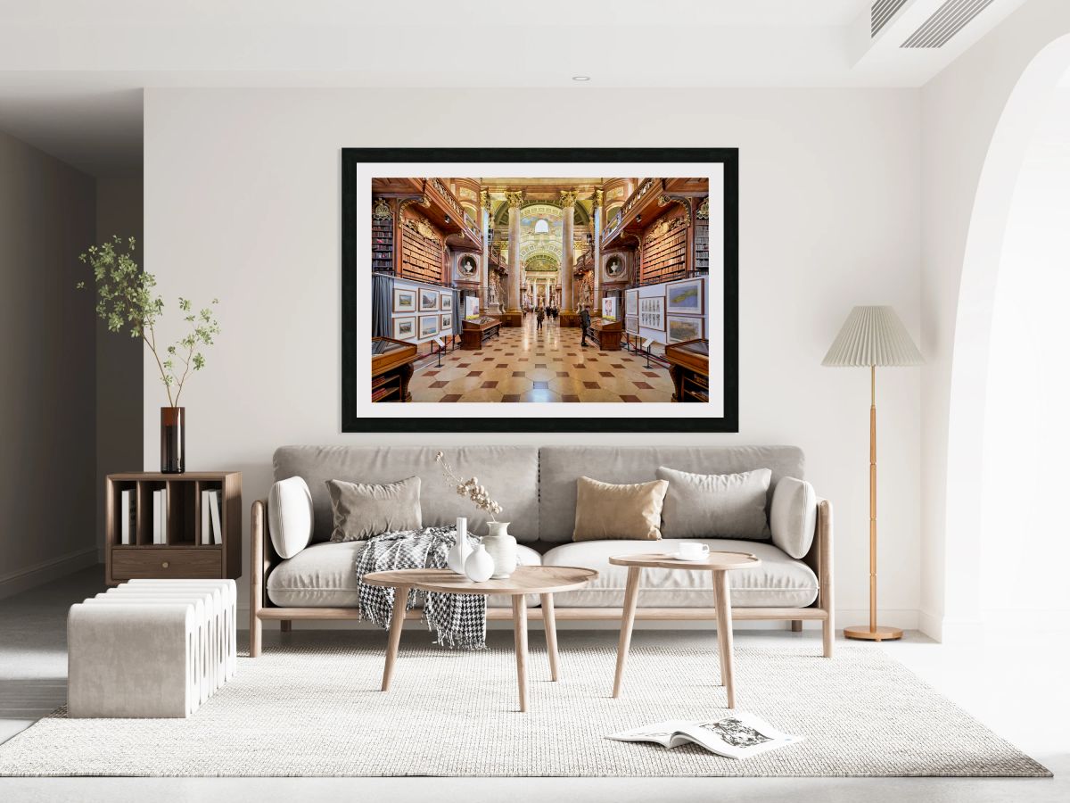 Grand ornate library interior with books columns and visitors