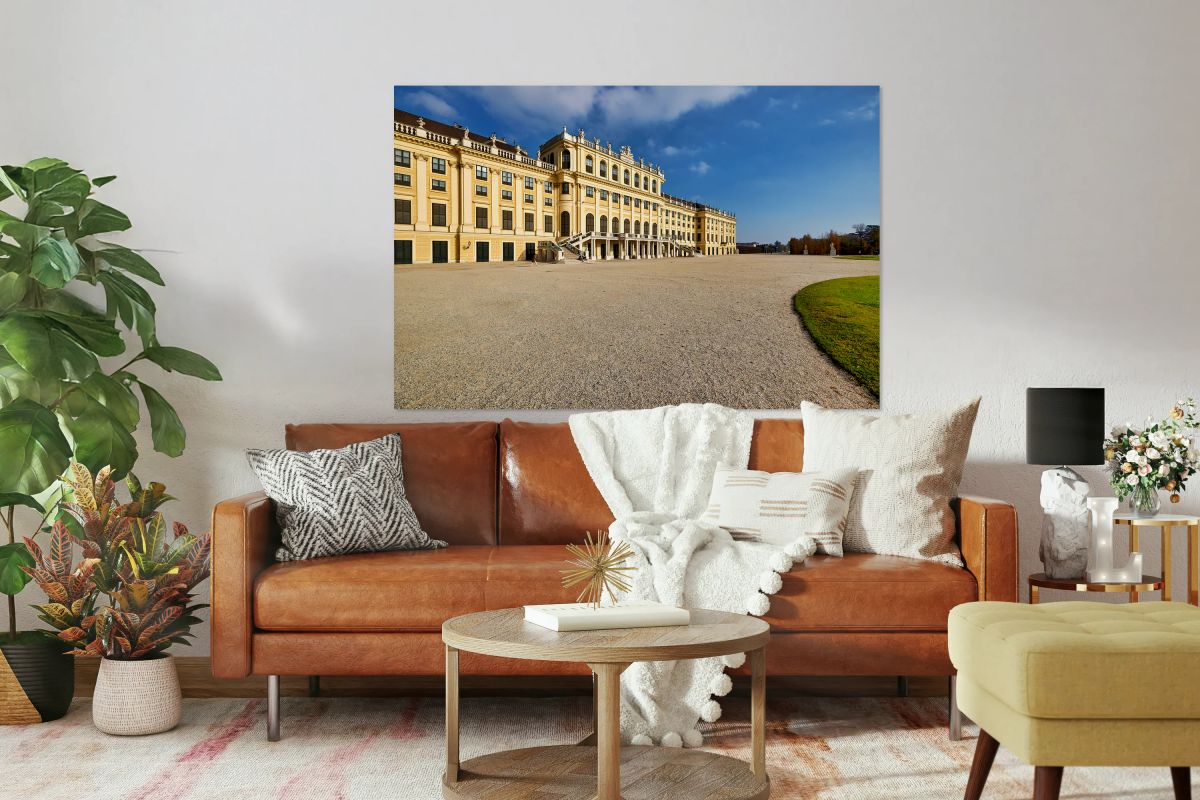 Majestic yellow palace gravel courtyard blue sky.