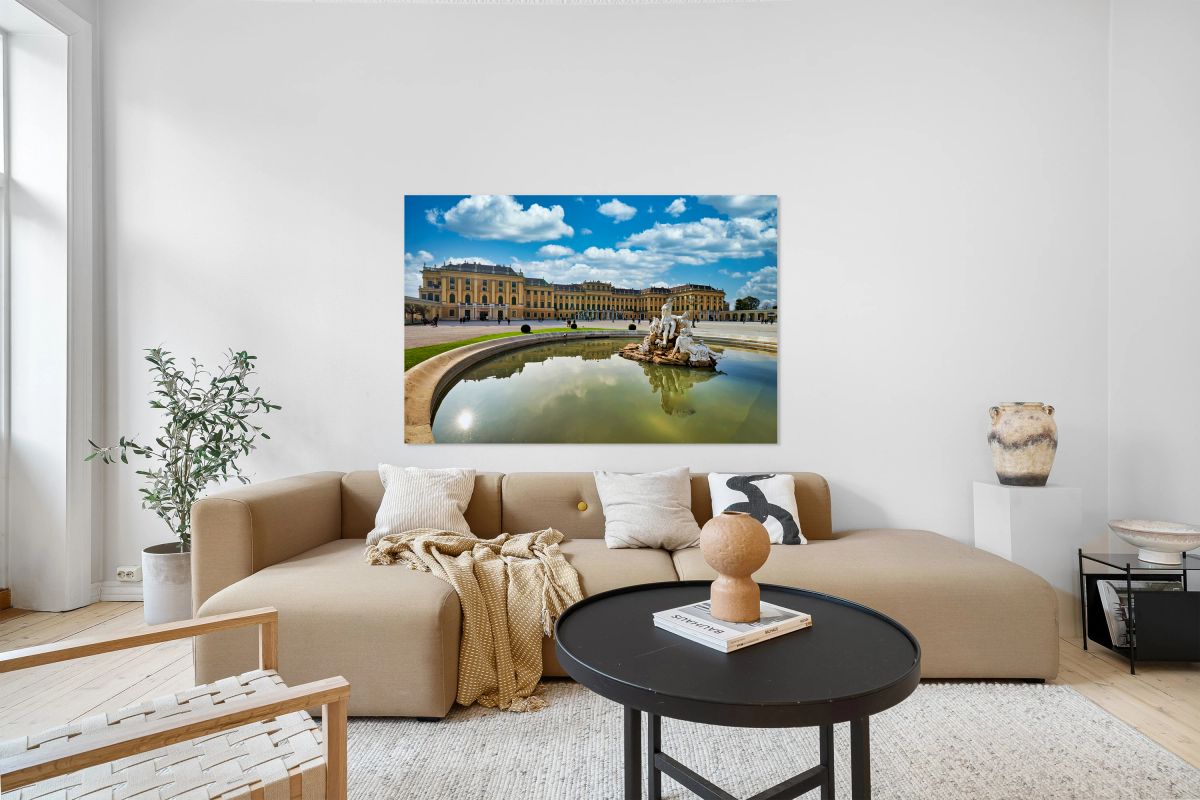 Schönbrunn Palace Vienna with Neptune Fountain and blue sky.