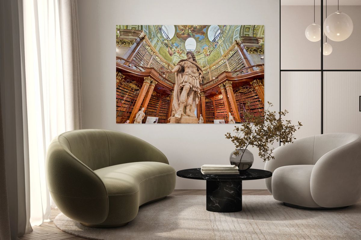 Grand baroque library with statue and painted ceiling.