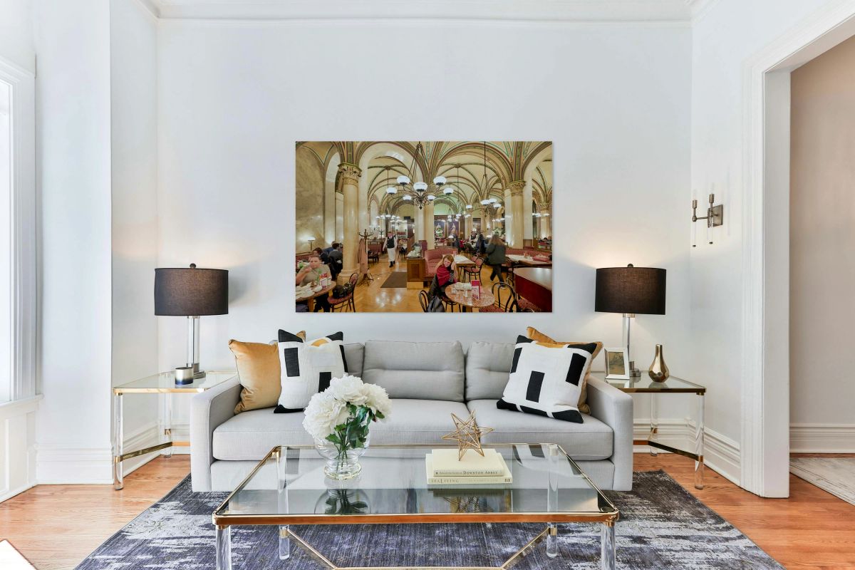 Elegant cafe bustling with customers and waiters.