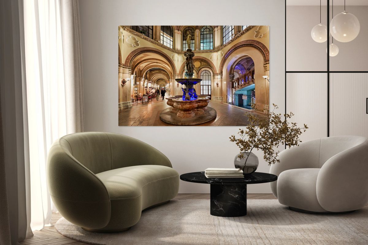 Palais Ferstel interior with fountain arches and people.