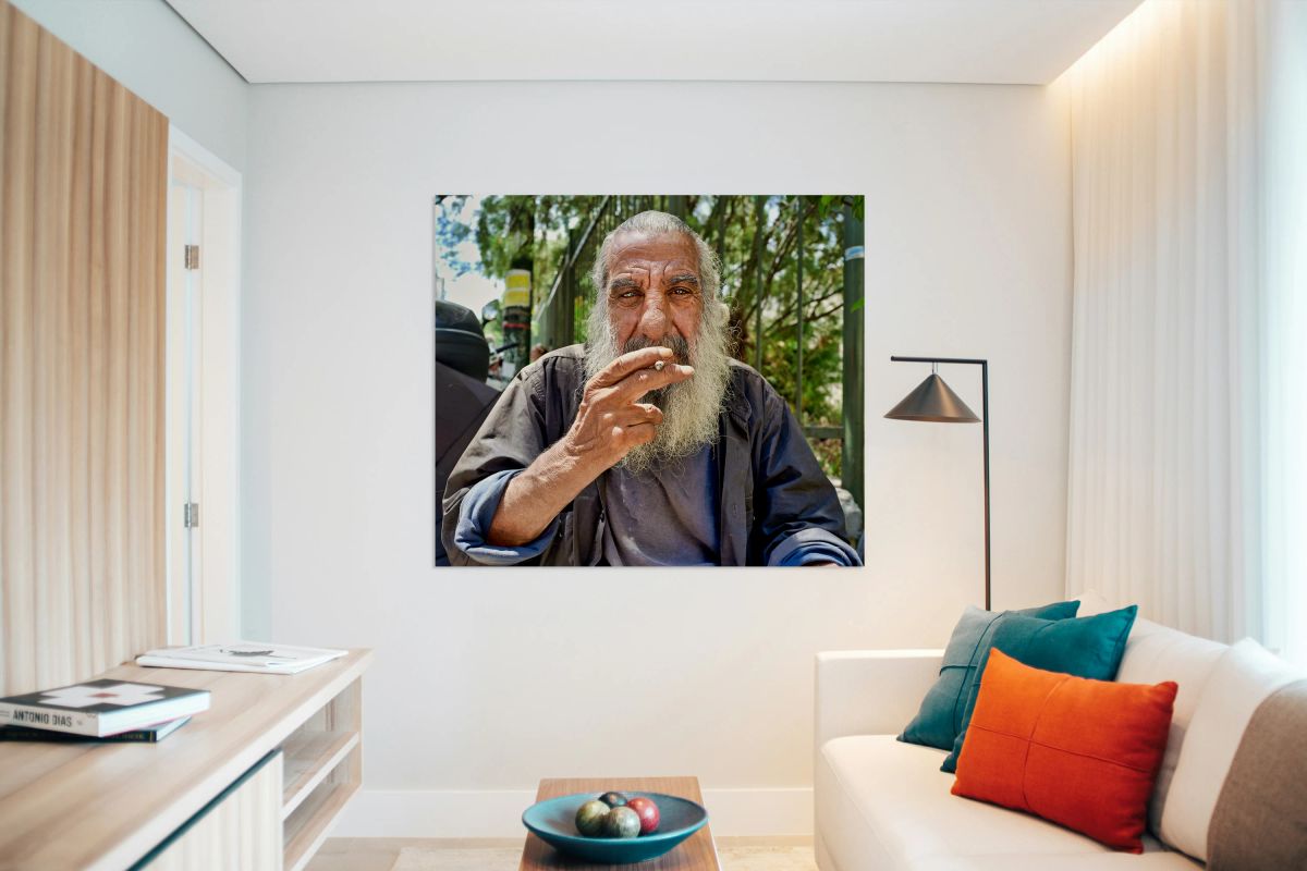 Man sitting outside with a cigarette and a beard