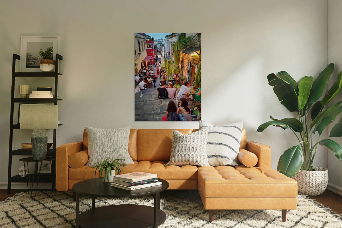 People enjoy drinks and food on a busy street in a city