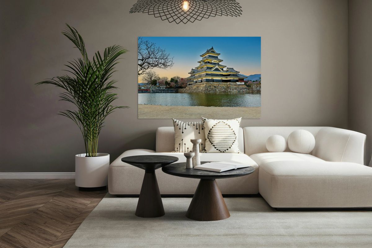 Matsumoto Castle standing by water during sunset in Japan