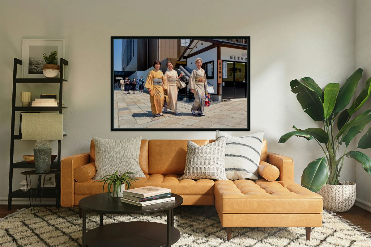 Smiling women in kimono walk through Kyoto streets during daytim