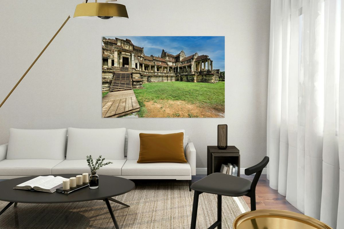 Ancient stone temple ruins wooden stairs green lawn blue sky.