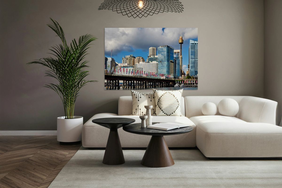 Sydney Harbour skyline with bridge and flags.