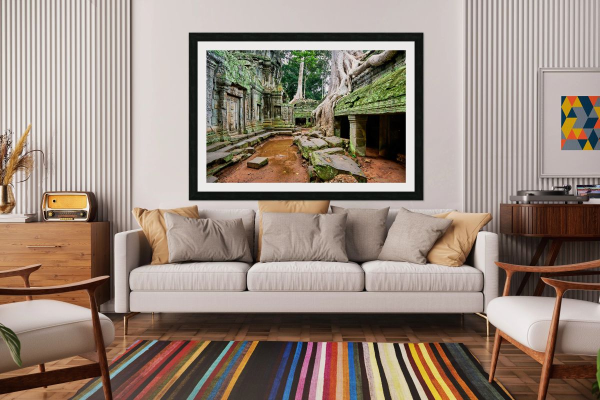 Ancient temple ruins consumed by giant tree roots and jungle.