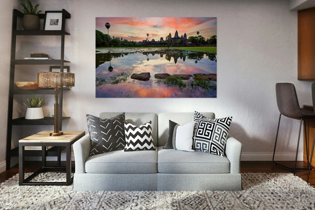 Angkor Wat temple reflected in water at sunset.