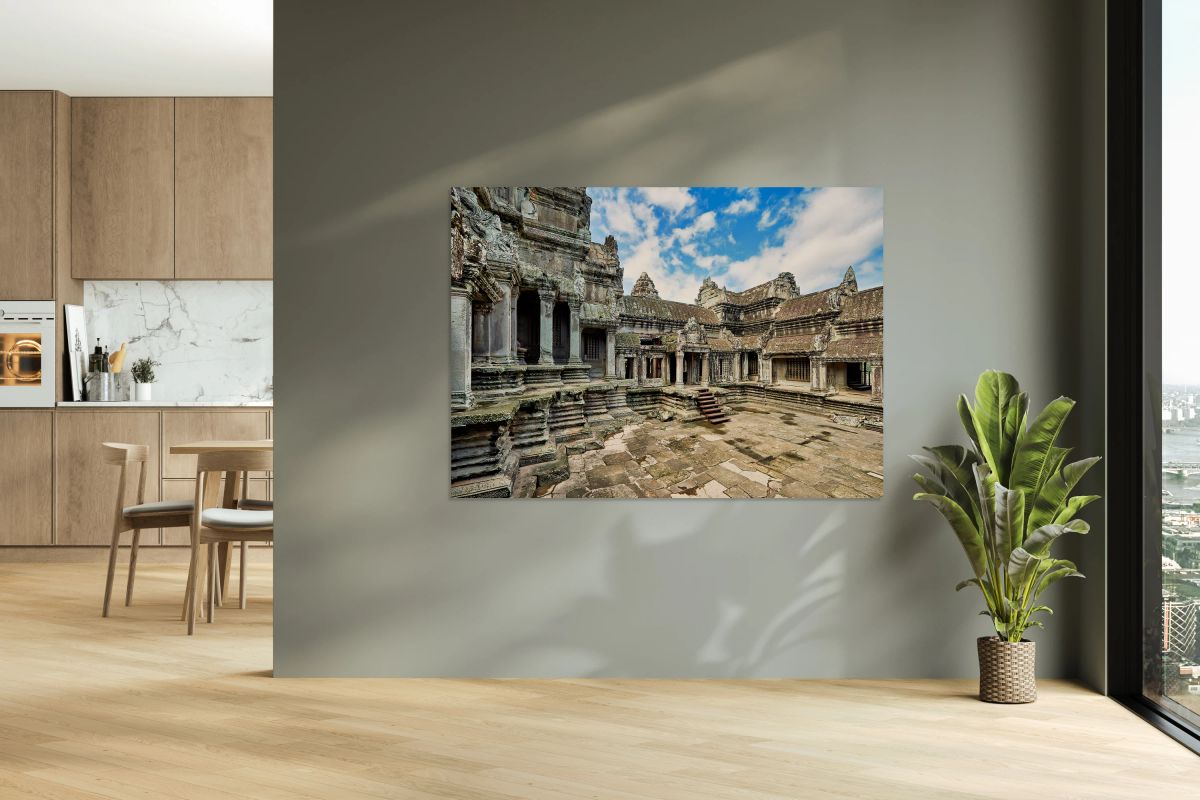 Ancient Angkor Wat temple complex under a blue sky.
