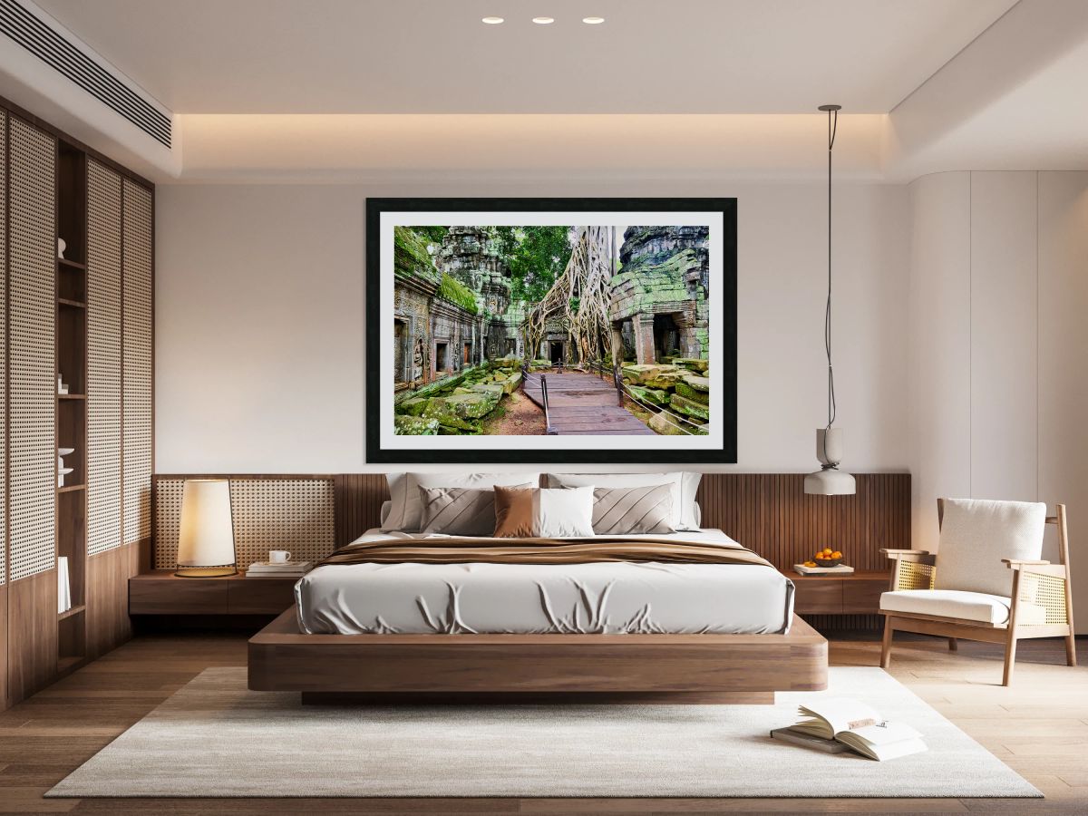 Massive tree roots engulf ancient temple ruins with moss.