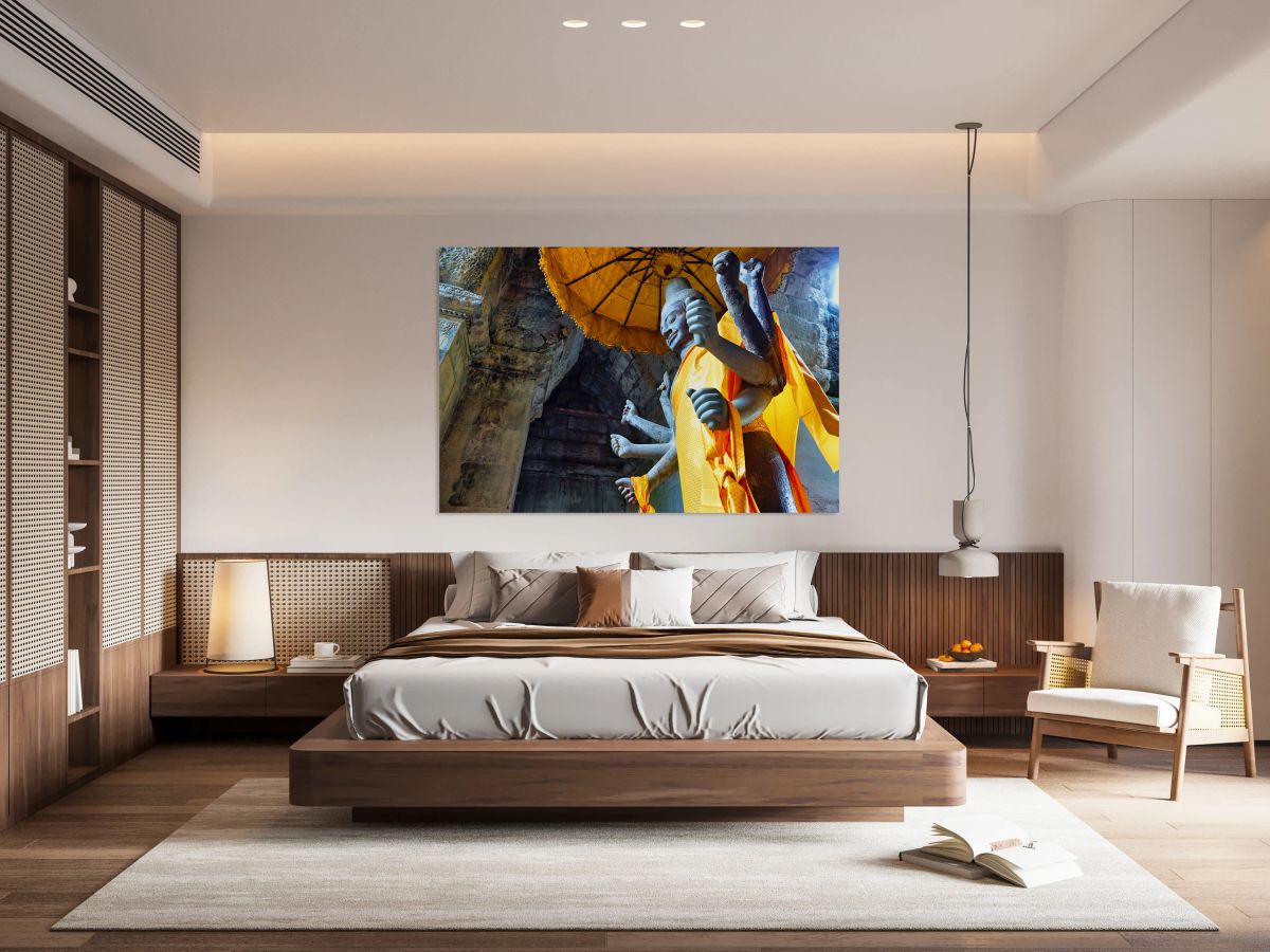 Ancient multi armed statue yellow fabric inside stone temple.