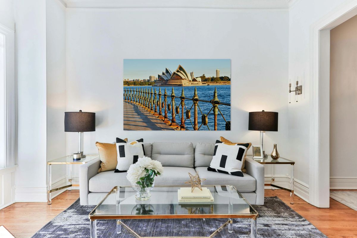 Sydney Opera House and harbor view at sunset.