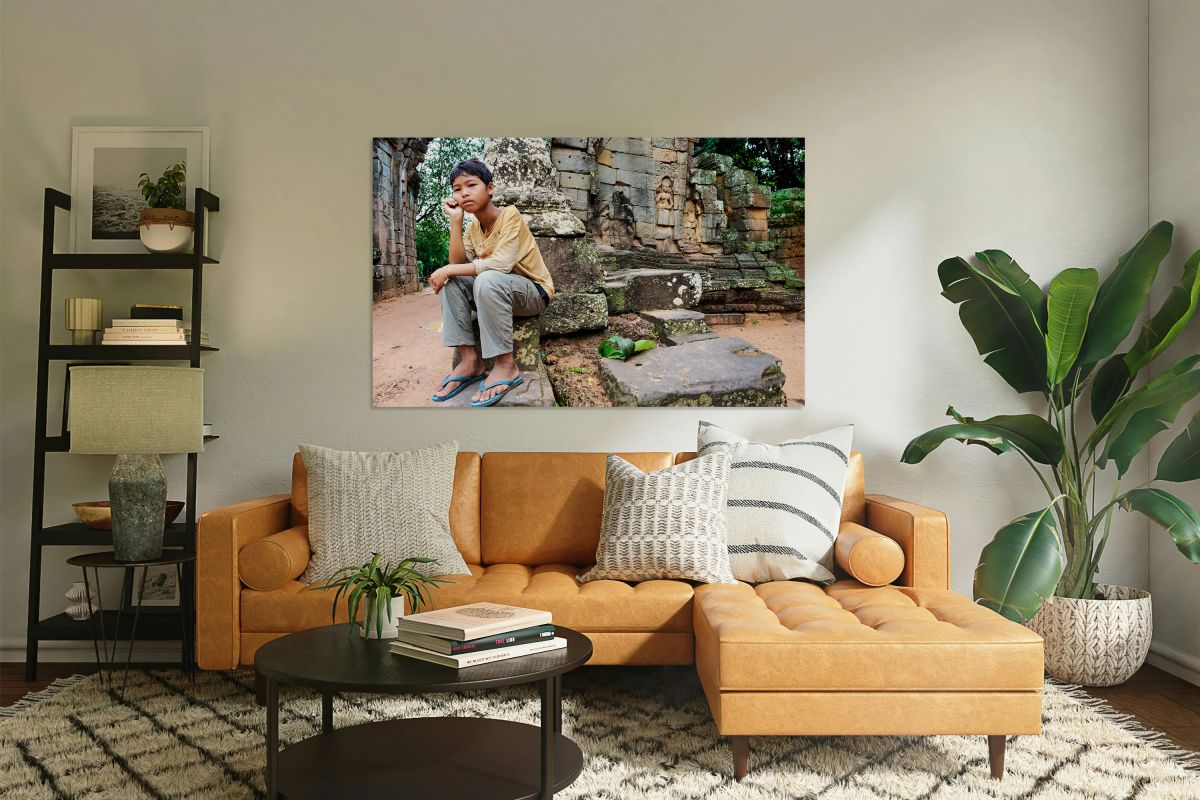 Young person sits on ancient temple ruins.