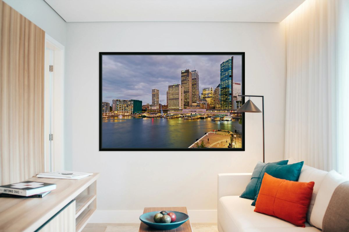 Sydney Harbour at dusk with ferries and city skyline.