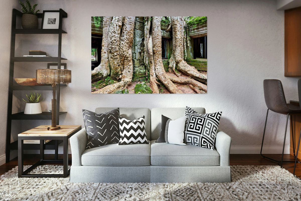 Giant tree roots engulf ancient temple ruins.