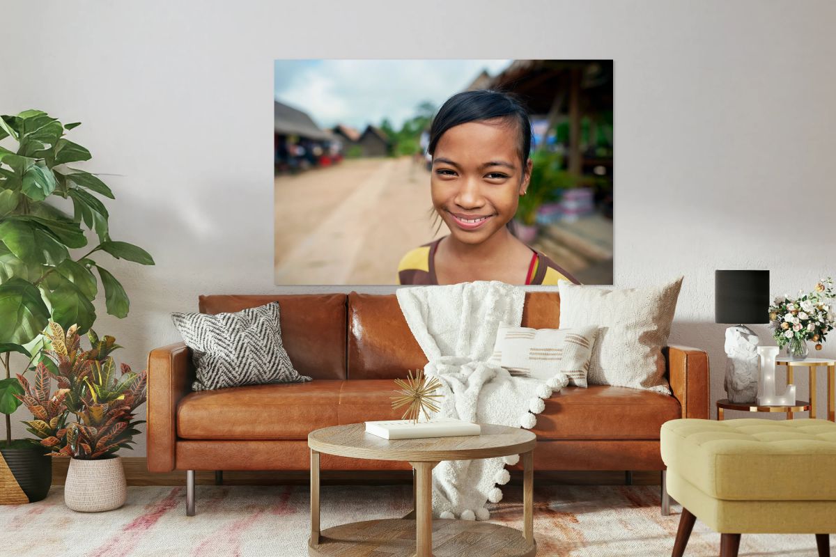 Smiling young girl in a village setting.